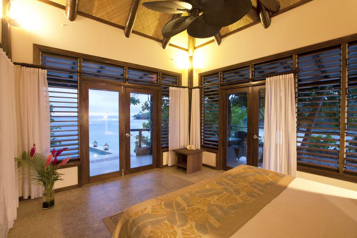 interior view of tropical hotel bedroom overlooking ovean