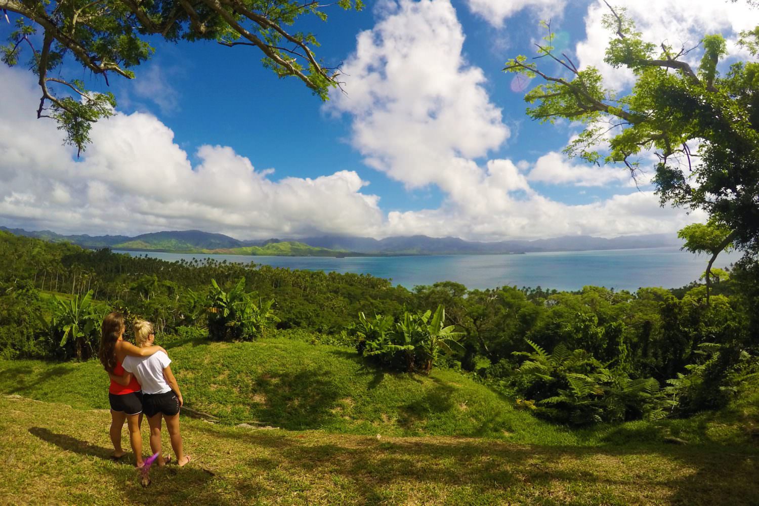 two women overlooking tropical rainforest and sea views