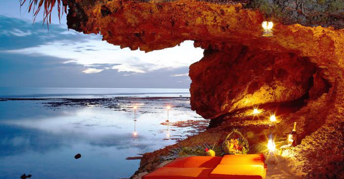 private night picnic in grotto overlooking the ocean