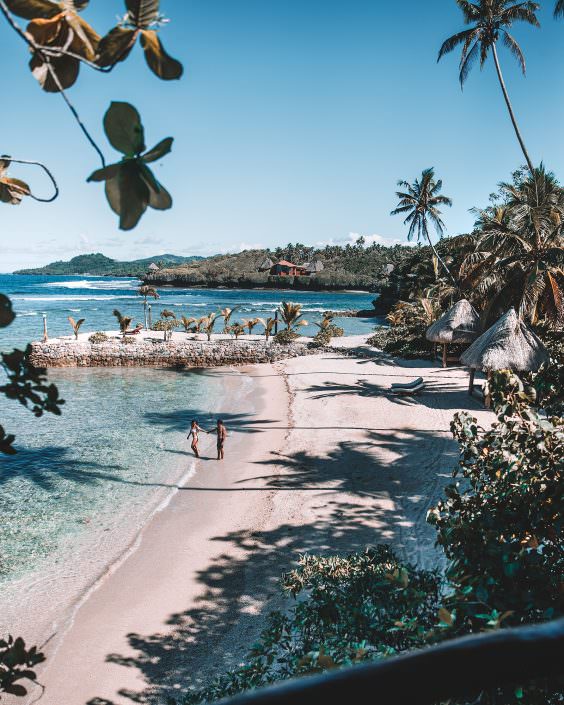 honeymoon couple walking on tropical private island beach
