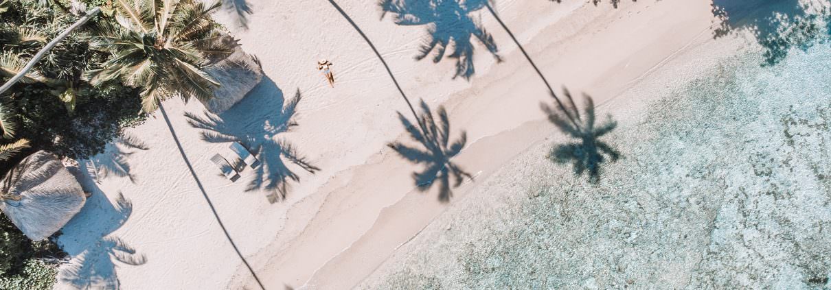 aerial view of woman laying on tropical beach