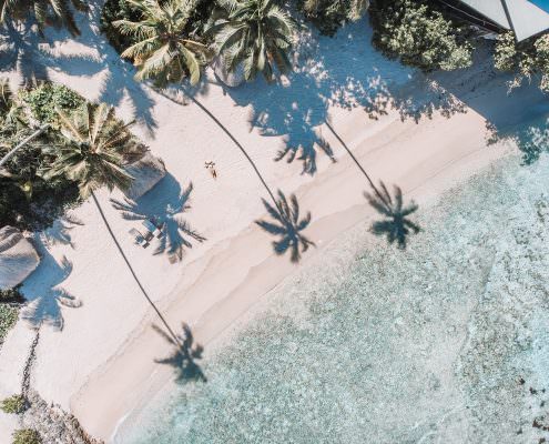 aerial view of woman laying on tropical beach