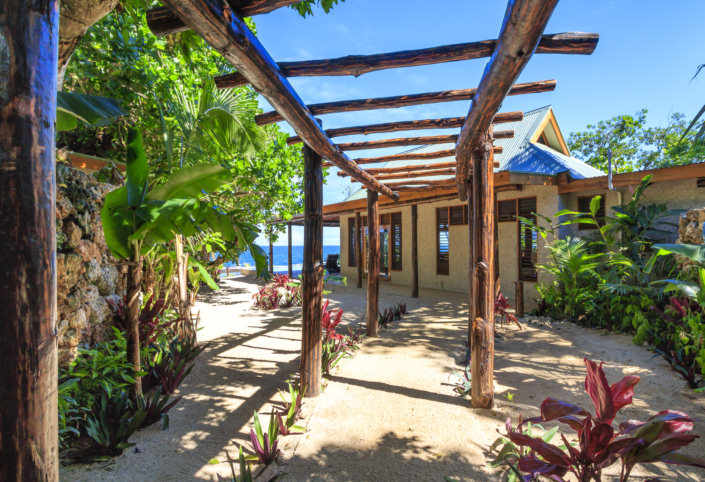 entrance to tropical villa accommodation overlooking ocean