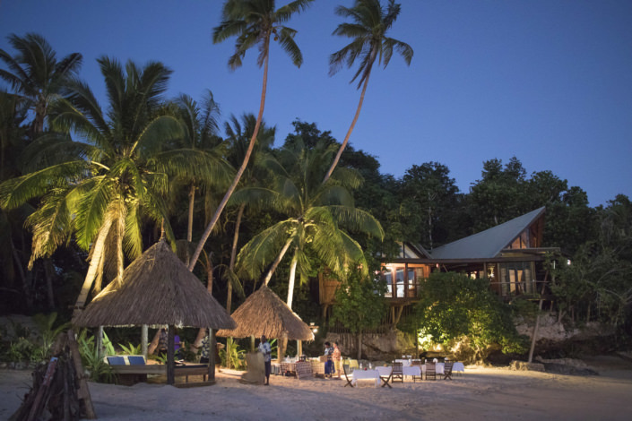 private island resort beach and outdoor dining settings