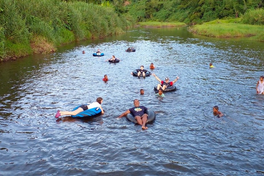 Group of tourists river tubing in Fiji