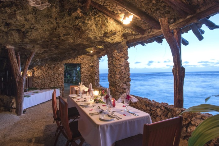 Romantic table setting in grotto overlooking the ocean