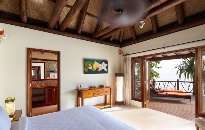 Private villa bedroom in Fiji overlooking the ocean