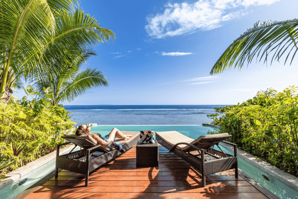 A woman lounging by the pool at Savasi Island Resort